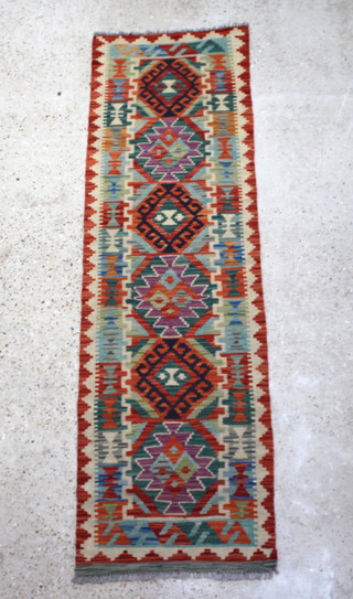 A yellow and multicoloured Kilim runner with 6 diamonds to the centre 195cm x 59cm
