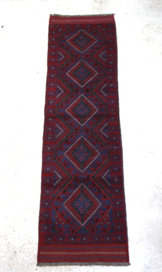 A blue and red ground Meshwani runner with 5 diamonds to the centre 240cm x 69cm 