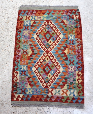 A yellow and blue ground Kilim with 2 diamonds to the centre within a geometric design 120cm x 79cm 