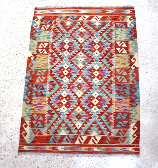 A yellow and turquoise ground Kilim with overall geometric designs 147cm x 102cm 