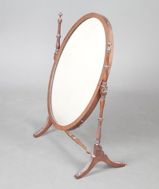 A Sheraton style oval plate dressing table mirror contained in a turned mahogany swing frame 69cm h x 46cm w x 27cm d  