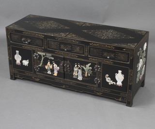 A Chinese rectangular black lacquered cabinet fitted 3 drawers and cupboards with inlaid hardstone decoration depicting Geishas and with floral panels to the sides  49cm h x 110cm w x 38cm d 
