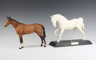 A Beswick figure "Spirit of Freedom" no.2689, white matt by Graham Tongue, 17.8cm on a wooden plinth and "Bois Roussel Racehorse" no. 701 by Arthur Greddington, matt brown, 20.3cm 