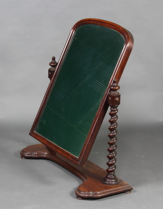 A Victorian arched plate dressing table mirror contained in a mahogany swing frame with spiral turned columns to the side, the base of serpentine outline 88cm h x 77cm w x 28cm d  