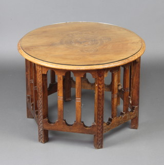 A circular carved Eastern hardwood occasional table raised on a pierced hexagonal base 49cm x 68cm diam. 