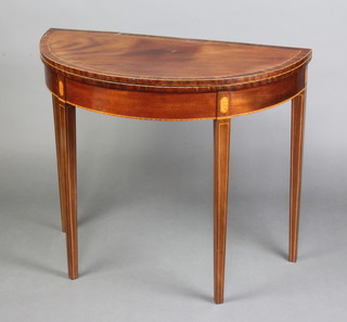 A 19th Century inlaid and crossbanded mahogany D shaped card table raised on square tapered supports 74cm h x 87cm w x 43cm d 