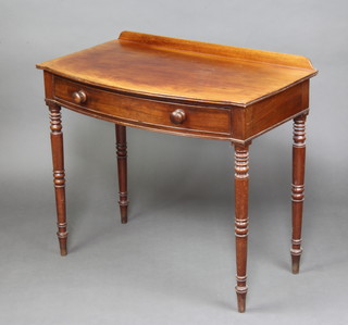 A 19th Century mahogany bow front side table with raised back fitted a drawer with tore handles, raised on turned supports 81cm h x 92cm w x 53cm d 
