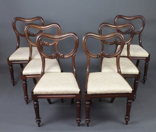 A set of 6 William IV mahogany buckle back dining chairs with carved mid rails, upholstered drop in seats, raised on turned supports 