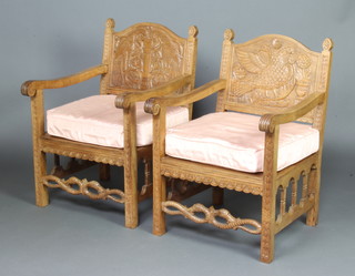A pair of Continental carved and bleached hardwood open arm chairs, the backs carved mythical birds with serpent carved stretchers 