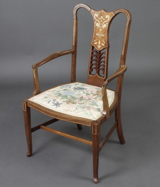 An Edwardian inlaid mahogany open armchair with upholstered seat raised on turned supports 