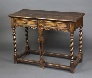 A 17th Century style oak side table, the top formed of 3 planks fitted 2 frieze drawers, raised on spiral turned supports with box framed stretcher 48cm h x 114cm w x 49cm d 