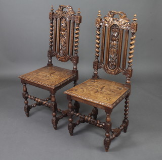 A pair of Victorian carved oak Carolean style high back hall chairs with pierced slat backs and spiral turned decoration, raised on turned supports with H framed stretchers 