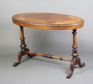 A Victorian oval figured walnut occasional table with quarter veneered top raised on turned supports with H framed stretcher 68cm h x 105cm w x 59cm d 