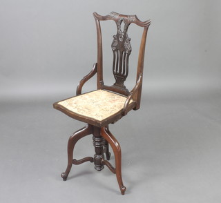An Edwardian Chippendale style slat back revolving adjustable harpists stool, raised on cabriole supports  
