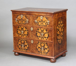 An 18th Century style Dutch marquetry chest, the inlaid and crossbanded top decorated an oval arrangement of flowers, fitted 2 short and 2 long drawers with drop handles, raised on bun feet 66cm h x 80cm w x 45cm d  
