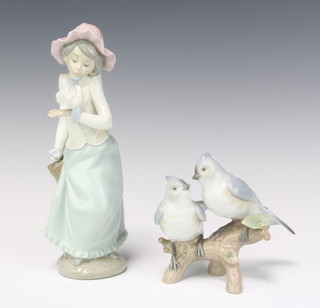 A Lladro group of 2 birds on a stump 10cm, a Nao figure of a girl with a dove 15cm 