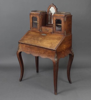 A Victorian inlaid raised wood bonheur du jour, the raised superstructure to the back fitted an arch shaped mirror above a drawer flanked by  a pair of cupboards enclosed by glazed panelled doors, the fall front revealing a fitted interior with well, raised on cabriole supports 140cm x 81cm x 54cm d 