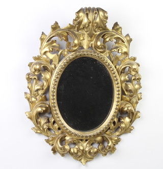 An oval plate mirror contained in a pierced gilt wood frame 45cm x 35cm 