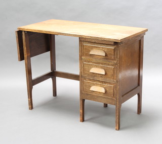 A Globe Wernicke oak desk fitted a brushing slide, 3 drawers and with a flap to the side 69cm h x 89cm w x 45cm d 