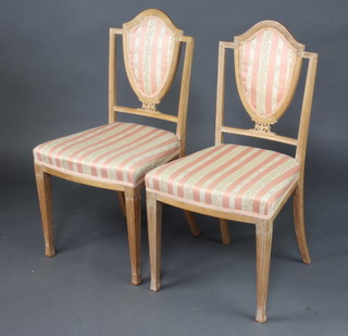 A pair of Hepplewhite style bleached mahogany shield back dining chairs