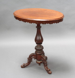 A Victorian style oval carved mahogany wine table on a carved pillar and tripod base 72cm h x 63cm w x 43cm d 
