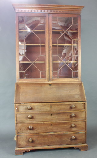 A Georgian mahogany bureau bookcase, the upper section with moulded cornice fitted adjustable shelves enclosed by astragal glazed panelled doors, the base fitted a fall front above 4 long drawers 126cm h x 107cm w x 63cm d (one glass panel damaged, the back feet are missing and requires overall restoration) 