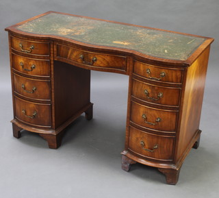 A Georgian style walnut desk of serpentine outline with inset writing surface above 1 long and 8 short drawers raised on bracket feet 75cm h x 115cm w x 53cm 