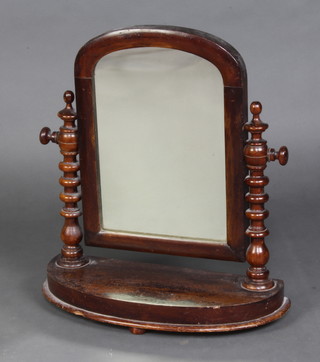 A Victorian arch plate dressing table mirror contained in a mahogany swing frame with bobbin turned decoration and raised on a D shaped base 50cm h x 48cm w x 18cm d