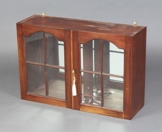 A 19th Century mahogany wall mounted display cabinet fitted shelves enclosed by arched astragal glazed doors 40cm h x 73cm x22cm d