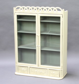A 19th Century Continental green painted pine hanging cabinet with pierced cornice, fitted shelves enclosed by glazed panelled doors, base fitted 1 long and 2 short drawers with ceramic tore handles 101cm h x 73cm w x 22cm d 