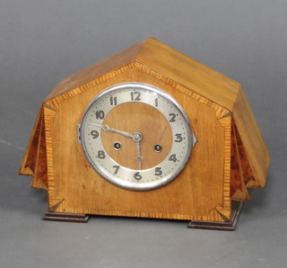 A 1930's Art Deco chiming mantel clock with silvered dial and Arabic numerals contained in a shaped inlaid and crossbanded mahogany case 