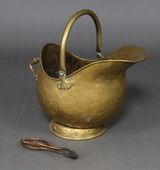 A brass helmet shaped coal scuttle 