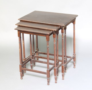 An Edwardian mahogany nest of 3 interfitting coffee tables on turned supports 53cm h x 45cm w x 32 cm d