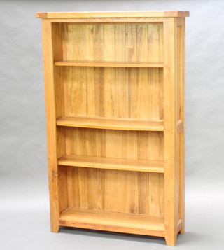 A light hardwood bookcase fitted adjustable shelves 156cm h x 198cm w x 31cm d 
