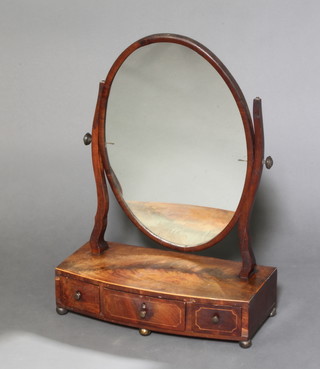 A 19th Century oval plate dressing table mirror contained in a mahogany swing frame raised on a bow front base fitted 3 drawers 58cm h x 43cm w x 20cm 