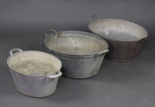 Three oval galvanised metal twin handled baths 27cm h x 56cm l x 42cm w, 23cm x 55cm x 44cm, 20cm x 44cm x 35cm 