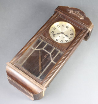 A 1930's striking wall clock with silvered dial and Arabic numerals contained in a mahogany finished case 