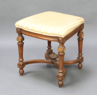 A carved oak Carolean style stool raised on turned and fluted supports with X framed stretcher, over stuffed seat 48cm x 48cm x 46cm (formerly a chair) 