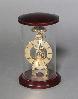 A reproduction Victorian striking skeleton clock with silvered chapter ring and Roman numerals contained in a mahogany and glass case