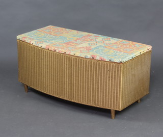 A gold painted Lloyd Loom  ottoman with hinged lid raised on turned supports 44cm x 90cm x 43cm 