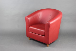 A Marks and Spencers tub back armchair upholstered in red material 