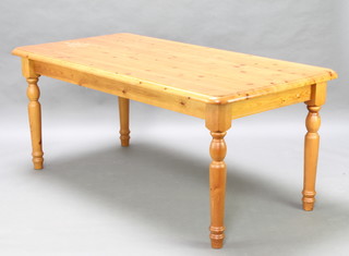 A rectangular pine dining table on turned supports 78cm h x 181cm l x 90cm w  