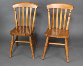 A pair of pine Windsor style stick and bar back dining chairs 