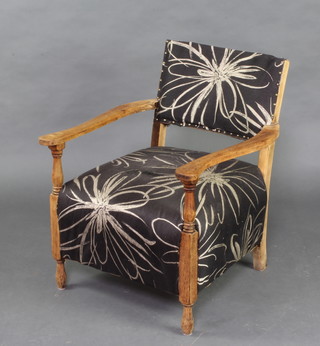 An Art Deco oak open arm chair 