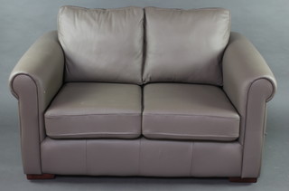 A 2 seat sofa upholstered in grey leather 64cm h x 144cm w x 96cm h together with a matching armchair