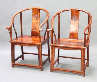 A pair of Chinese Padauk judgement chairs with solid seats, raised on turned supports (one spindle is f and r)