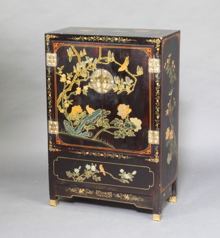 A Chinese lacquered cabinet enclosed by panelled doors decorated birds 91cm h x 61cm w x 31cm d, the top with ring marks 
