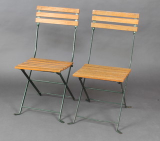 A pair of Bistro style metal and slatted wooden folding chairs 