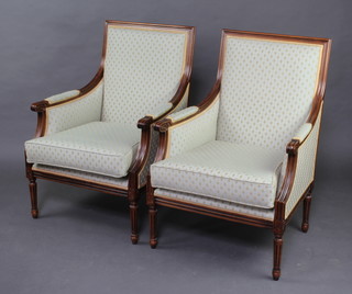 A pair of French style carved mahogany show frame armchairs, the seats and backs upholstered in pale blue material 