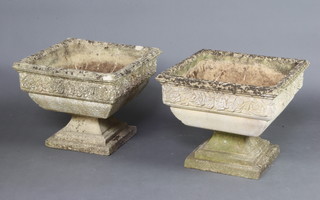A pair of square well weathered concrete garden urns, raised on stepped bases 80cm x 51cm x 51cm (some slight chips to the base and top of 1) 
